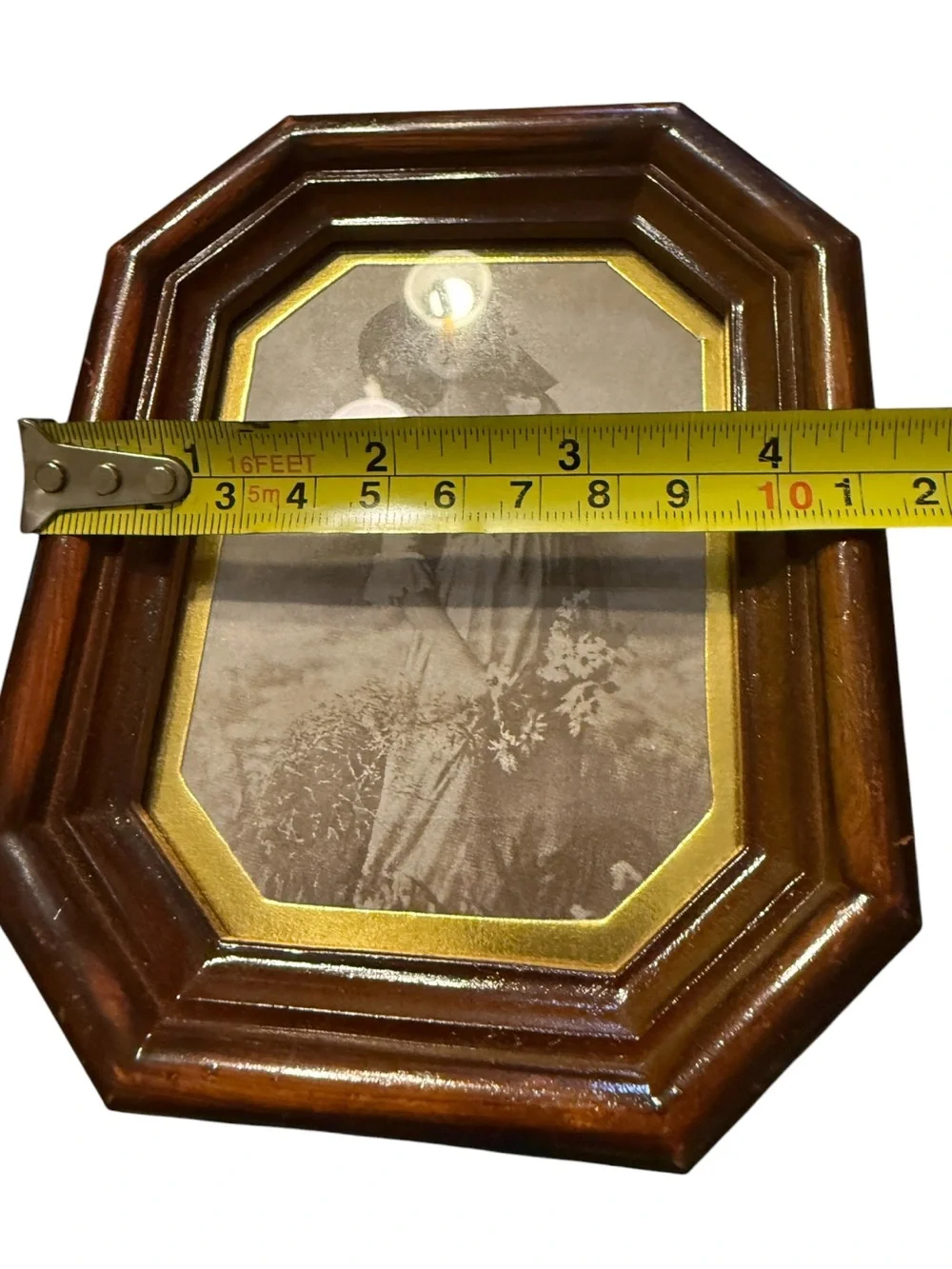 vintage octagonal wood-finish photo frame features a classic portrait insert and